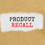 Text "Product Recall" on torn brown paper.