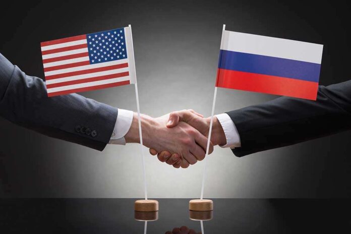 282618053 featured image Two people shaking hands beneath US and Russian flags