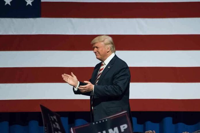 487546282 featured image Man clapping in front of American flag background