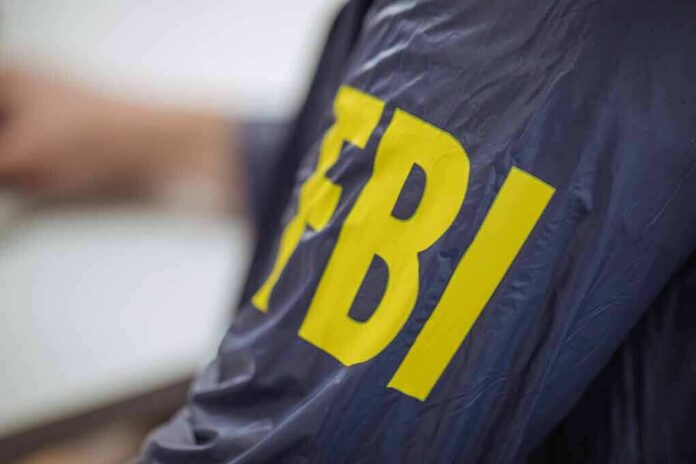 612694196 featured image Person wearing jacket with "FBI" in yellow letters.