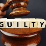 Gavel hitting guilty blocks on a wooden podium