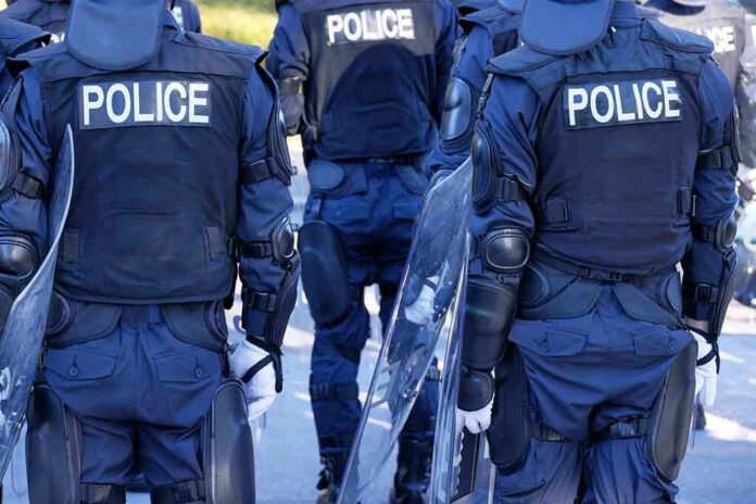 1952009191 featured image Police officers in riot gear with shields.