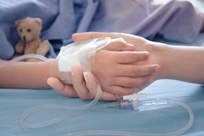 1168304533 featured image Child's hand with IV held by adult