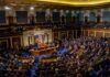 Legislative chamber filled with people during a session