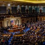 Legislative chamber filled with people during a session