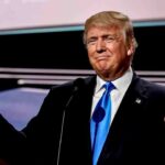 Man in suit giving thumbs up gesture