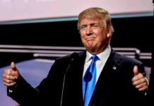 Man in suit giving thumbs up gesture