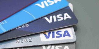 Stacked Visa credit cards in various colors.