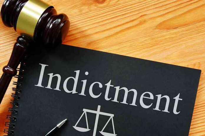 2138821999 featured image Gavel next to indictment document on wooden table.