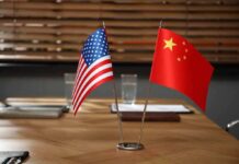 American and Chinese flags on a conference table.