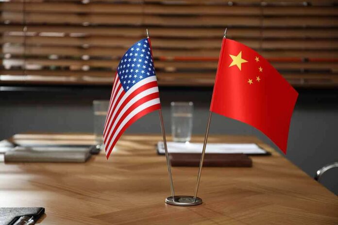2183327065 featured image American and Chinese flags on a conference table.