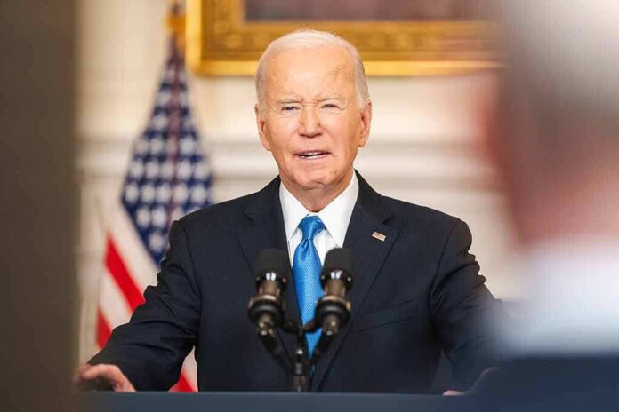 2425911677 featured image Man in suit speaking at a podium with microphones.