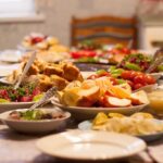 Table set with various colorful dishes and fruits