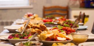 Table set with various colorful dishes and fruits