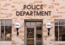 Police department building with brick exterior and signage.