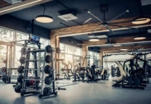 Modern gym with fitness equipment and weight racks