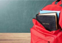 Red backpack with a Bible and books inside