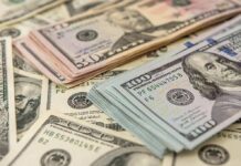Stacks of various U S dollar bills