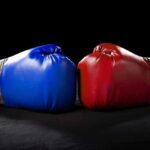 Blue and red boxing gloves facing each other