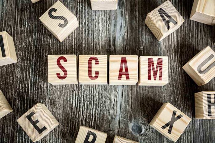 343236656 featured image Wooden blocks spell SCAM on a rustic surface