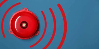 Red alarm bell on a blue background