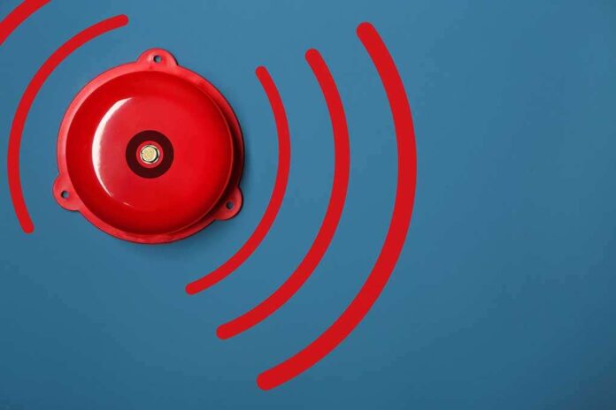 1311134939 featured image Red alarm bell on a blue background