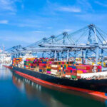 Container ship docked at a busy industrial port