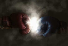 Red and blue boxing gloves clashing with smoke