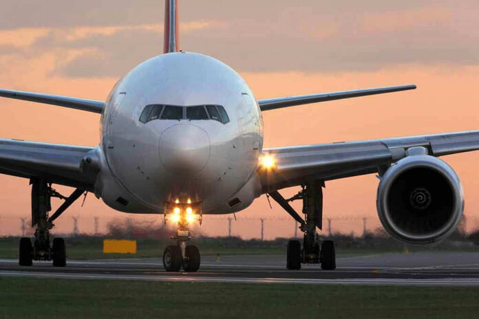 Airplane on runway during sunset