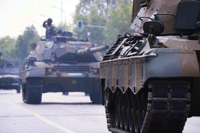 Tanks on a road with soldiers inside