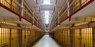Long hallway with prison cells on both sides