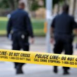 Online Extremists Fueling Shockingly Random Attacks Police officers walking past caution tape at a crime scene
