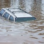 DEVASTATING Floods Kill 800 — Government Negligence EXPOSED A partially submerged vehicle in floodwaters