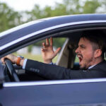Road Rage Horror: Pregnant Teen’s Tragic End Man yelling inside a car, looking frustrated.