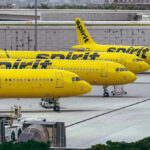 Yellow airplanes parked on the airport tarmac.