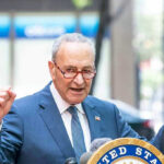 DEMS FLIP – Senate Shutdown Threat Stuns Government! Man in suit speaking passionately at outdoor event.