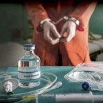 Vial labeled Sodium Thiopental near handcuffed person.