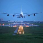Passengers Slammed Into Ceiling—4,400-Foot Freefall Horror An airplane approaching the runway at night with landing lights illuminated
