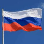 Russia’s “Immunity” Rattles D.C – Move BACKFIRED The flag of Russia waving against a clear blue sky