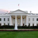 White House Scandal: Congressman’s Intimate Pics LEAKED! The White House with a fountain in the foreground and an American flag flying
