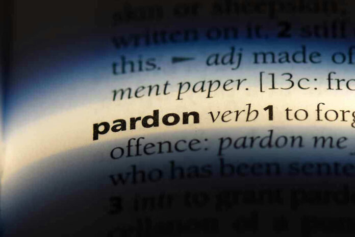 The word pardon highlighted in a dictionary.