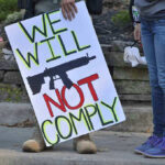 200,000 Men PROTEST – Defying Government! Protest sign reads: We Will Not Comply.