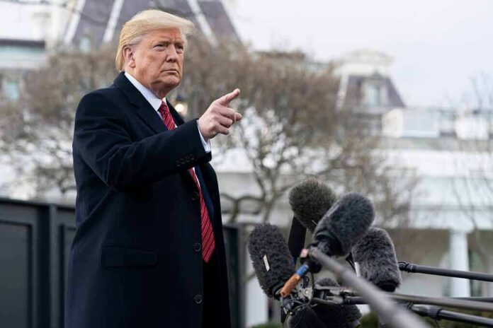 Donald Trump gesturing while speaking to the press outside