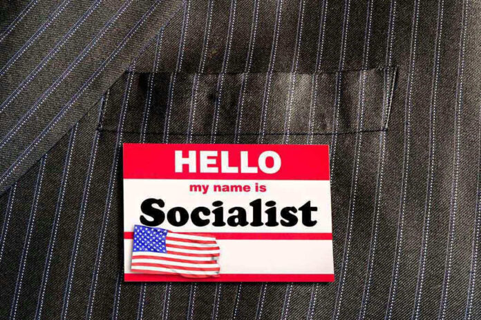 Hello my name is Socialist name tag on suit.