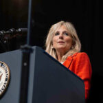 Jill Biden’s Ex-Husband’s Wife Dead – Domestic Disturbance CALLED Person speaking at podium with Vice President seal.