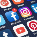 Social media app icons on a smartphone screen.
