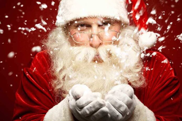 Santa Claus blowing snowflakes with a joyful expression