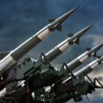 Array of missile launchers positioned against a dramatic sky