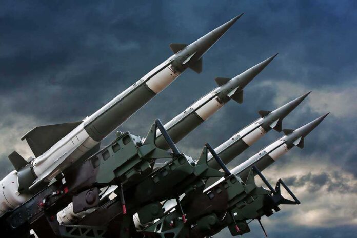 Array of missile launchers positioned against a dramatic sky