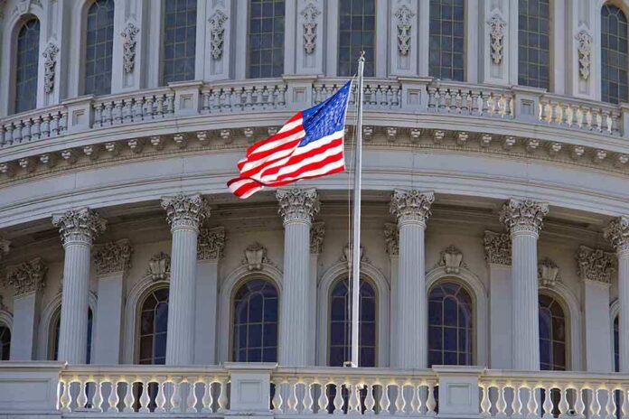 American flag waving in front of the Capitol building
